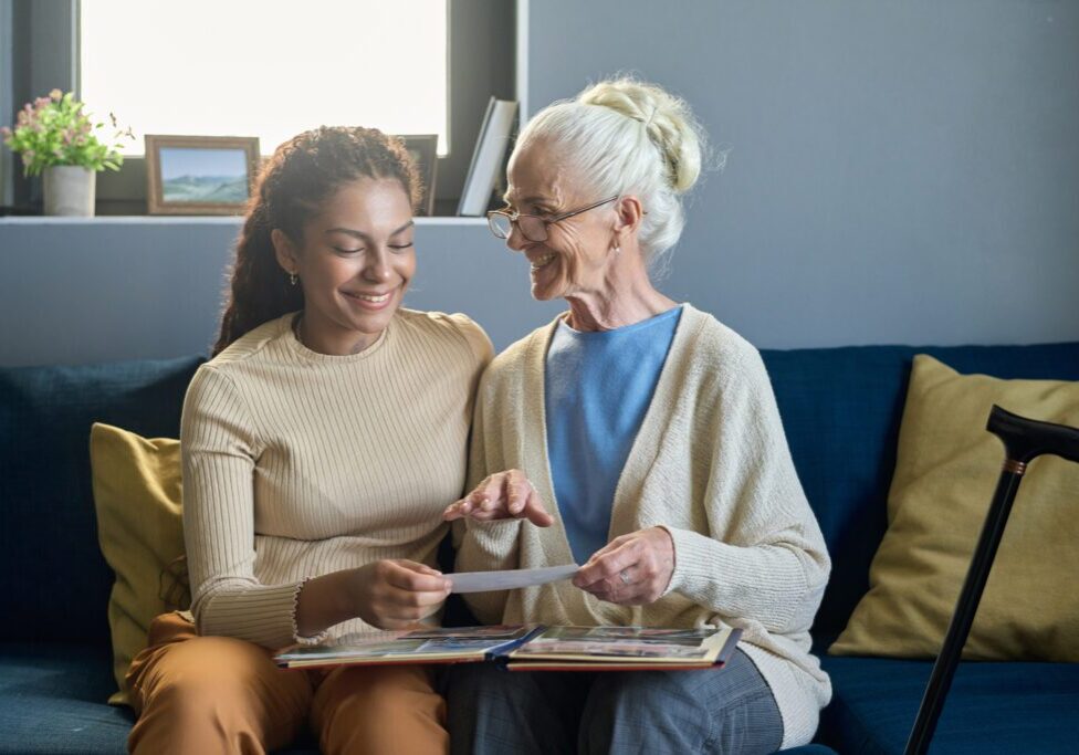 Grandmother and granddaughter looking at photos together.